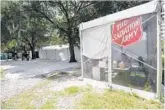  ?? WILLIE J. ALLEN JR./ORLANDO SENTINEL ?? A tent that housing about 75 men stands Thursday outside the Salvation Army in downtown Orlando.