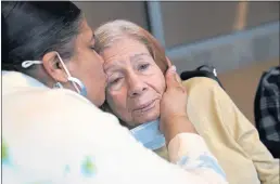  ?? KATHY WILLENS — THE ASSOCIATED PRESS ?? Rosa DeSoto, left, embraces her 93-year-old mother, Gloria DeSoto, who has dementia, inside the Hebrew Home at Riverdale in New York on March 28.