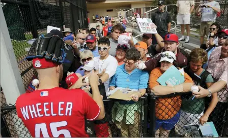  ?? FRANK FRANKLIN II — THE ASSOCIATED PRESS ?? The Phillies’ Zack Wheeler signs autographs after a workout on Friday in Clearwater, Fla.