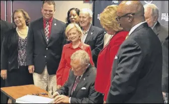  ?? JAMES SALZER/JSALZER.AJC.COM ?? Gov. Nathan Deal signed the fiscal 2018 state budget in Atlanta on Monday.