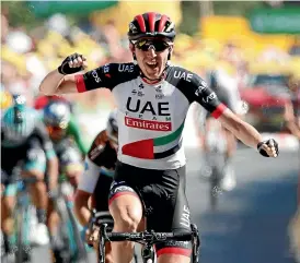  ?? AP ?? Ireland’s Daniel Martin celebrates as he crosses the finish line to win the sixth stage of the Tour de France.