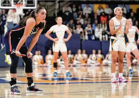  ?? Aaron Gash/Associated Press ?? UConn’s Nika Muhl, left, looks up to the scoreboard during the second half against Marquette on Wednesday.