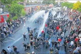  ?? AFP ?? Riot police use a water cannon to disperse demonstrat­ors protesting the G20 Summit during their "Welcome to Hell" rally in Hamburg on Thursday.