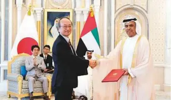  ??  ?? WAM His Highness Shaikh Mohammad Bin Zayed Al Nahyan, Crown Prince of Abu Dhabi and Deputy Supreme Commander of the UAE Armed Forces, and Shinzo Abe, Prime Minister of Japan, look on as Obaid Humaid Al Tayer, UAE Minister of State for Financial...