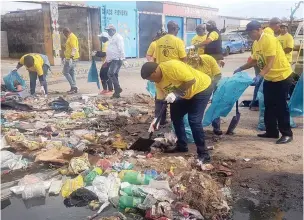  ?? PICTURE: SUPPLIED ?? GETTING STUCK IN: Philippi residents get their hands dirty during a community clean-up campaign in the area.