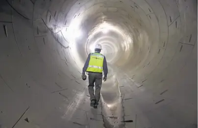  ?? Photos by Paul Chinn / The Chronicle ?? Central Subway Program Director John Funghi heads into the northbound tunnel below Fourth Street.