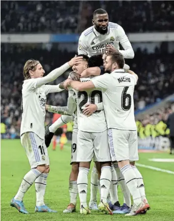  ?? Picture: GETTY IMAGES/DENIS DOYLE ?? ON TARGET: Vinicius Junior of Real Madrid (obscured) celebrates with his teammates after scoring the team's first goal during their LaLiga Santander match against Valencia at Estadio Santiago Bernabeu.