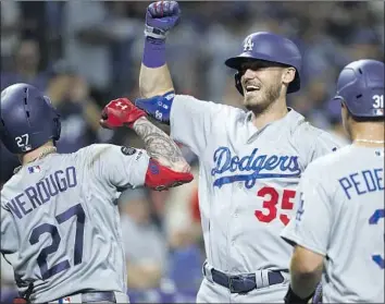  ?? Photograph­s by Matt Slocum Associated Press ?? ALEX VERDUGO, Cody Bellinger and Joc Pederson celebrate Verdugo’s two-run blast in the eighth inning. The Dodgers didn’t get to Philadelph­ia until after 4 a.m. following a 12-inning game Sunday night in Boston.