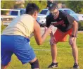  ?? JIM THOMPSON/JOURNAL ?? A masked Kevin Barker, right, works with a Hope Christian player on Friday. Barker is the former head coach at Manzano and Sandia, and how he is a Huskies assistant.