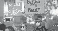  ?? THOMAS HAWTHORNE/ THE REPUBLIC ?? Protesters hold signs at a rally calling for defunding the Phoenix Police Department outside City Council chambers in Phoenix on Tuesday.