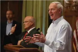  ?? (Arkansas Democrat-Gazette/ Thomas Metthe) ?? Gov. Asa Hutchinson (right) answers a question during the daily COVID-19 briefing on Saturday, May 23, at the state Capitol in Little Rock.