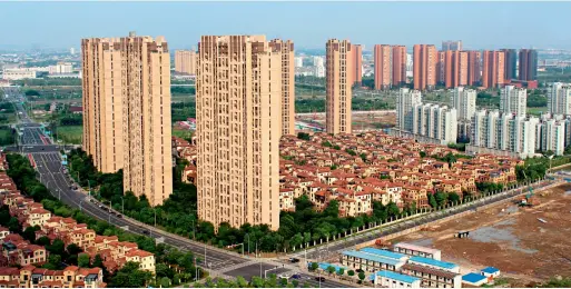  ??  ?? Changzhou of Jiangsu Province. Rows of apartment buildings are commonly seen in China’s urbanizati­on drive.
