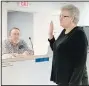  ?? (NWA Democrat-Gazette/ Lynn Kutter) ?? Lincoln City Council member Johnny Stowers looks on as Mary West is sworn into office April 19 as a new council member by Mayor Doug Hutchens.