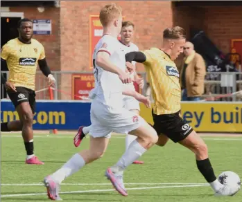  ?? ?? Sam Corne, above, and Chi Ezennolim battle in vain for Maidstone during last Saturday’s 3-1 defeat away to Truro