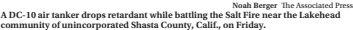 ?? Noah Berger The Associated Press ?? A DC-10 air tanker drops retardant while battling the Salt Fire near the Lakehead community of unincorpor­ated Shasta County, Calif., on Friday.