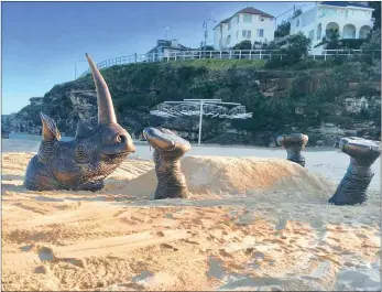  ?? PICTURE: JESSIE SCHATTNER ?? A massive African rhino, sinking symbolical­ly beneath the sand, has been erected on a popular beach in Sydney, Australia, as part of an outdoor art exhibition to raise awareness about the horn-poaching world-wide. It was designed by Sydney artists...