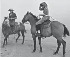  ?? MIKE CLARK/THE BILLINGS GAZETTE VIA AP ?? Isaac Slabaugh and Fannie Stutzman are surrounded by smoke as a wildfire moves toward Ashland, Mont.