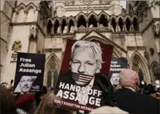  ?? Alberto Pezzali/Associated Press ?? Demonstrat­ors hold placards Tuesday after Stella Assange, wife of Wikileaks founder Julian Assange, released a statement outside the Royal Courts of Justice in London.