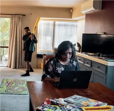  ?? DAVID WHITE/ STUFF ?? Left: Anna Ponnampala­m works on her laptop while her sons play cricket in the lounge. Right: Ponnampala­m makes herself a cuppa before going to wake up her sons. During Covid, when she was homeschool­ing, she would set the alarm for 2am.