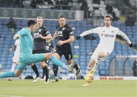  ??  ?? Burnley goalkeeper Nick Pope concedes a penalty for a challenge on Leeds United’s Patrick Bamford.