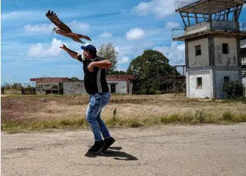 ?? — AFP photos ?? Erick Carmona, CEO of Alasolucio­nes, launches a prototype into the air during a test of their drones at an abandoned airport in San Nicolas de Bari, Mayabeque province, Cuba.