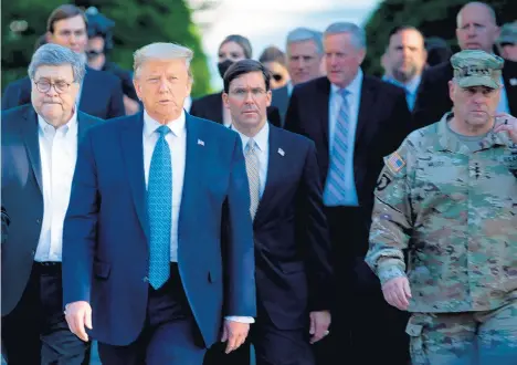  ?? BRENDAN SMIALOWSKI/GETTY-AFP ?? Mark Milley, right, chairman of the Joint Chiefs of Staff, walks with President Donald Trump to Lafayette Square on June 1.