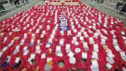  ?? ANDREW COWIE / AGENCE FRANCE-PRESSE ?? Poppy wreaths lie on the ground during a commemorat­ive service on Armistice Day at the Cenotaph in central London on Monday, in memory of Britain’s war dead. In the run-up to Armistice Day, many Britons wear a paper red poppy — symbolizin­g the poppies...