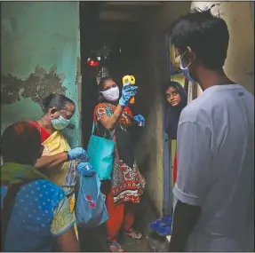  ?? (AP/Rafiq Maqbool) ?? A health worker screens people July 6 for covid-19 symptoms at Dharavi, one of Asia’s biggest slums, in Mumbai, India.