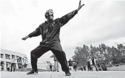  ?? RICK BOWMER/AP ?? David Christophe­r Coons, who is homeless, performs tai chi in Salt Lake City. Coons was fired from his job as an electricia­n about five years ago and has been homeless since.