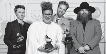  ??  ?? Heath Fogg, from left, Brittany Howard, Steve Johnson and Zac Cockrell, of Alabama Shakes, pose in the press room with the awards for best alternativ­e music album for “Sound & Color,” best rock song for “Don’t Wanna Fight,” and best rock performanc­e...