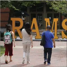  ?? STEVE HELBER - THE ASSOCIATED PRESS FILE PHOTO ?? In this June 20, 2019, file photo students walk around a RAMS sign at Virginia Commonweal­th University in Richmond, Va. Families with 529 college savings plans may have seen their totals tumble due to recent economic events caused by the coronaviru­s pandemic. But that downturn also has interest rates on undergradu­ate federal student loans potentiall­y decreasing to less than 3%, the lowest rate in more than 15 years.