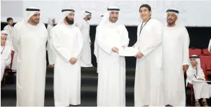  ?? Supplied photo ?? Dr Sheikh Majid bin Saeed Al Nuaimi (centre) honours one of the winners. —