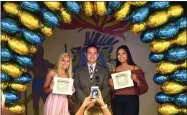  ?? RECORDER PHOTO BY CHIEKO HARA ?? Portervill­e Police Explorers Scholarshi­p winners Kathryn Trevino, left, and Felipa Acosta, right, take a photo with presenter OIC Wayne Martin Thursday, May 24, after the annual Monache High School Scholarshi­p Night at the Campus Center.