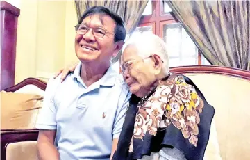  ??  ?? Photo shows Kem Sokha (left) sitting with his mother Sao Nget while confined by the government at his residence in Phnom Penh. — AFP photo