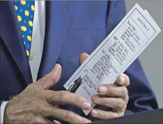  ?? Andrew Harnik Associated Press ?? THE DEMOCRATIC candidate holds his notes, including a reference at the top to his possible running mate Kamala Harris, before he speaks at a campaign event on July 28.