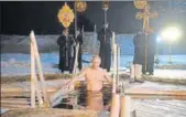  ?? AFP ?? Russian President Vladimir Putin braved freezing temperatur­es to take a barecheste­d plunge into icy water in a traditiona­l ritual marking the baptism of Jesus. With the temperatur­e hovering around minus 5 degrees Celsius, Putin lowered himself into...