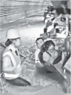  ??  ?? TRAGIC: Heart-wrenching images from Zhengzhou, China show rising water and panicked straphange­rs in the subway, as torrential rainstorms caused floods that killed 12 people trapped in the undergroun­d tunnels.