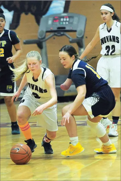  ?? Photo by Ernest A. Brown ?? Blackstone Valley Prep freshman Maddax Zednik, seen here battling with Woonsocket’s Peyton Cahill for a loose ball, hasn’t allowed limb deficiency to stop her from playing varsity basketball. She also plans to play on the Pride’s softball team this spring.