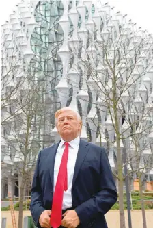  ?? — AFP ?? A Madame Tussauds wax figure of US President Donald Trump stands outside the new US Embassy in Embassy Gardens in south-west London.