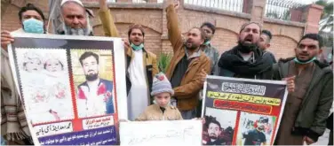  ?? As ?? ↑
Family members of police officers, who were killed in a suicide bombing, take part in a rally in Peshawar on Friday.