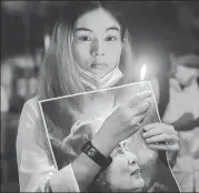  ?? REUTERS ?? A woman in Bangkok holds a picture of detained Myanmar leader Aung San Suu Kyi at a protest against the coup.