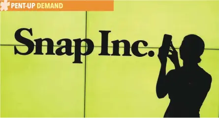  ?? — Reuters ?? A woman stands in front of the logo of Snap Inc on the floor of the New York Stock Exchange while waiting for Snap Inc to post their IPO.