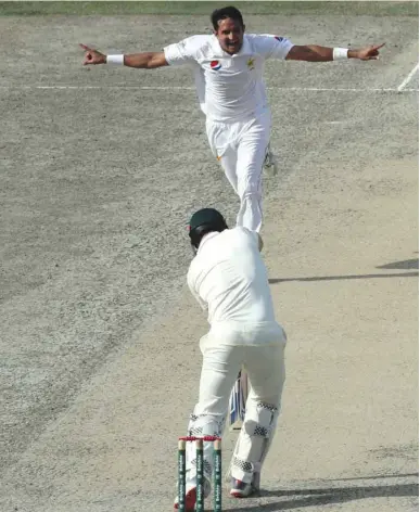  ?? (AFP) ?? Pakistan’s Mohamed Abbas (top) celebrates after taking the wicket of Australia’s Shaun Marsh during the fourth day of the first Test in Dubai yesterday.