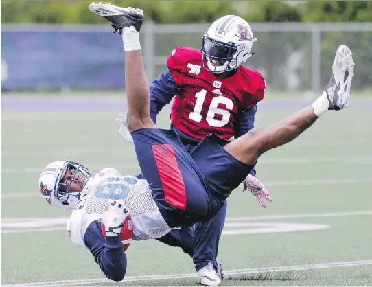  ?? JOHN MAHONEY ?? Alouettes receiver Devon Bailey comes down after making a leaping catch in front of defensive back Ronald Tyler during training camp at Bishop’s University on Monday.