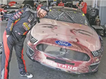  ?? JOHN RAOUX/ASSOCIATED PRESS ?? Corey LaJoie poses with a likeness of himself Friday at the Daytona 500.