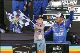  ?? THE ASSOCIATED PRESS ?? Kyle Larson, right, and his son Owen celebrate after winning a NASCAR Cup Series auto race and championsh­ip on Sunday, Nov. 7.