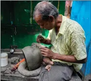  ?? ?? An artisan works on an idol of Hindu goddess Durga ahead of Durga Puja festival at Kumortuli.