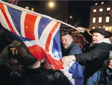  ?? MATT DUNHAM / THE ASSOCIATED PRESS ?? Pro-brexit and anti-brexit supporters shout at each other opposite the Houses of Parliament in London, where British lawmakers voted Thursday to postpone Britain’s departure from the European Union.