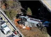  ?? DAN ANDERSON/AP ?? Response crews work at the scene Tuesday after a bus carrying high school band members plunged into a ravine.