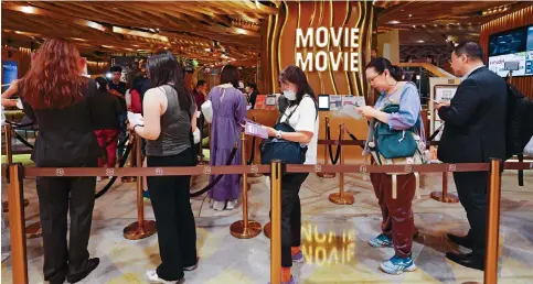  ?? Photo: Jelly Tse ?? People queue to buy tickets outside a cinema in Admiralty yesterday. The first Cinema Day last year attracted record single-day attendance of almost 222,000.